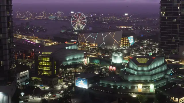 Aerial night view of the Vice City skyline, ferris wheel and waterfront
