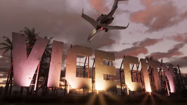 A plane flying over an enormous illuminated VICE sign at dusk