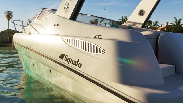 Side view of a white Squalo boat, with sun glare reflecting off it in the water.